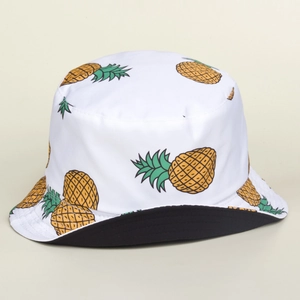 White bucket hat with cartoon pineapple prints and black reversible lining for sun protection