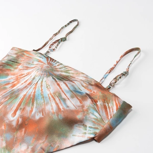 Detail of adjustable silver buckle on silk straps with orange and teal tie-dye print