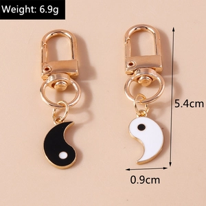 Macro view of gold Tai Chi Yin Yang pendants with dimensions 5.4cm and weight 6.9g