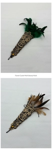 Detail of gothic lace wrist cuffs with feathers and yellow gemstones for party costumes