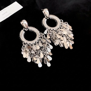 Silver geometric earrings featuring layered teardrop sequins and flowing metal tassels
