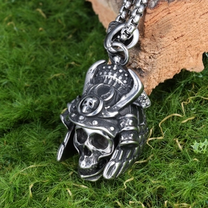 Biker style stainless steel samurai skull pendant with rustic vintage finish on moss stone