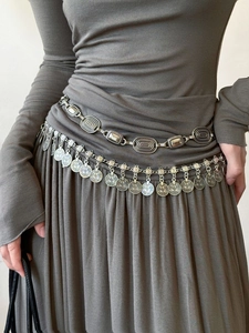 Detailed shot of bohemian silver chain belts with geometric links and round coin pendants