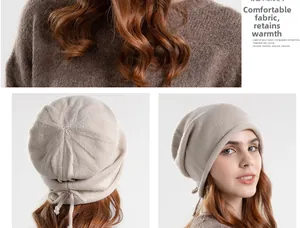 Detail of beige knit beanie showing ribbed texture and drawstring closure system