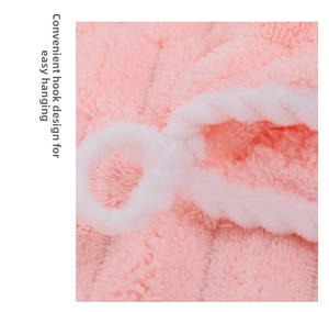 Detailed close-up of pink coral fleece hair towel featuring a convenient hanging hook