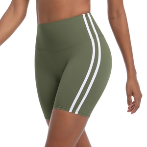 Detail view of olive green high-waisted yoga shorts with side white athletic stripes