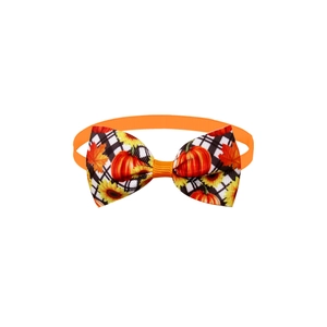 Detailed view of fall pet bowtie featuring pumpkins, sunflowers, and plaid patterns