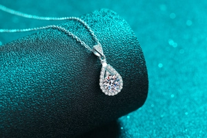 Macro shot of S925 sterling silver water-drop pendant necklace with moissanite halo