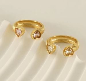 Detail of 18K gold-plated open ring featuring pink and clear heart zircon stones