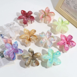 Detailed macro view of dual-layer butterfly hair claws with gradient marble textures
