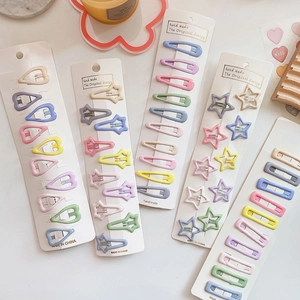 Flat lay of colorful candy-colored metal hair clips in heart, star and drop shapes