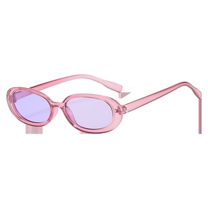 Detail of trendy cat-eye sunglasses with pink transparent frames and lavender lenses