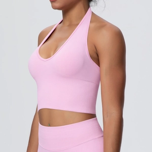 Detail of pink halter yoga bra showing seamless knit texture and supportive ribbed band