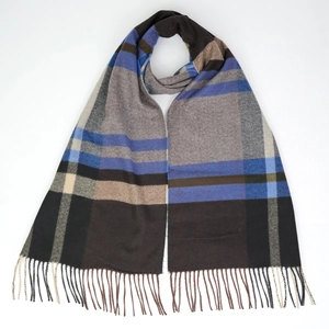 Close-up of soft plaid scarf fringe detail in brown, blue, grey, and beige