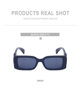 Front view of black gray rectangular sunglasses with thick acetate frames and dark gray lenses