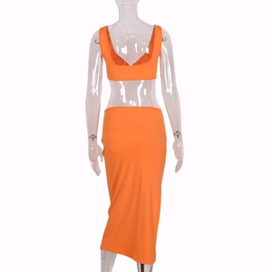Detail view of the back of a bright orange two-piece crop top and high waist midi skirt set