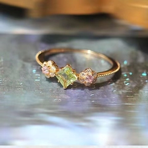 Vintage Peridot Ring mit grünem Stein und rosa floralen Akzenten auf Goldband