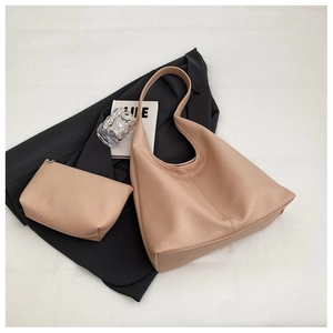 Close-up of pink leather tote bag featuring lychee texture and matching clutch set