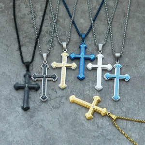 Macro shot of multi-layered stainless steel cross pendants with Lord's Prayer engraving