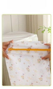 Detailed view of the durable mesh laundry bag showing its high elasticity and bear print
