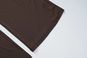 Détail de la double couture sur les poignets et l'ourlet en maille marron foncé