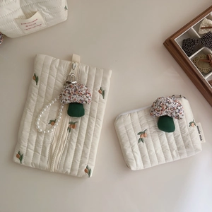 Quilted cotton pouches with embroidered floral patterns and mushroom zipper charms