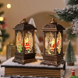 Detail of vintage bronze Christmas lanterns with Santa figures and swirling gold glitter