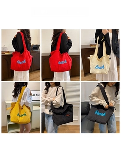Detail showing high-capacity canvas tote bags in four colors with Beach embroidery