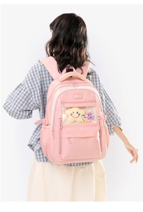 Pink waterproof nylon backpack detail with transparent window and plush star charm accessory