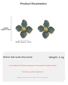 Detailed view of blue enamel flower earrings with 925 silver needles and gold center