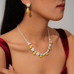 Detailed view of luxury zircon flower necklace and earrings set worn by a model