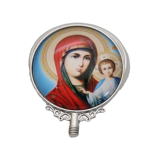 Religious icon metal ornament with circular glass inset and intricate floral hollow base