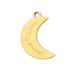 Close-up of golden moon pendant with Moon Kissed engraving made of stainless steel