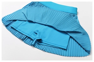 Detail view of bright blue pleated sports skort with built-in liner and wide waistband