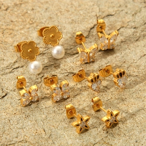 Set of five gold-toned butterfly and star earrings with zircon and pearl details