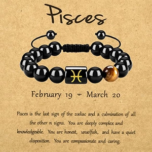 Pisces zodiac bracelet with tiger eye stone and black beads on vintage background