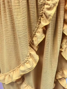 Macro shot of yellow pleated fabric texture with elegant ruffle edge details