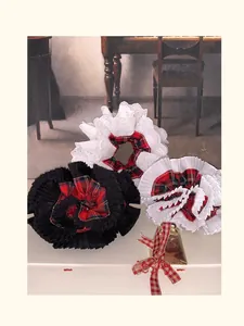 Detail of tartan pleated scrunchies with delicate lace trim and vintage style accents