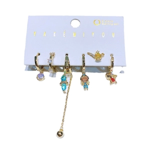 6-piece gold earring set with colorful zircon stones and fairy tale charms on white card