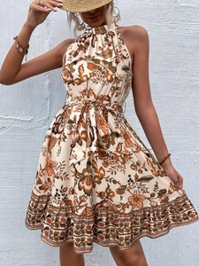 Detail of floral halter dress featuring orange-brown botanical prints and waist tie