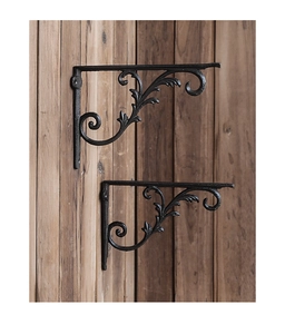 Close-up of vintage cast iron shelf bracket with elegant black floral scrollwork patterns