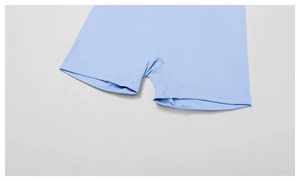 Detailed close-up of double-needle stitching and reinforced crotch on flared yoga pants