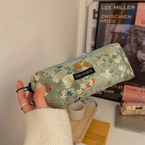 Floral embroidered light green pencil case with zipper and stylish brand label