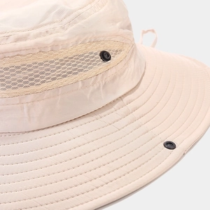 Detailed macro view of beige sun hat with breathable mesh and reinforced stitching