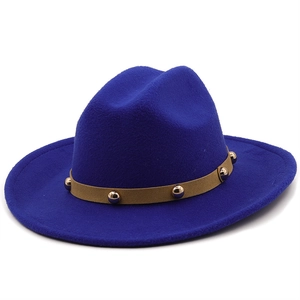 Close-up of royal blue wool fedora hat featuring a brown leather band with gold studs