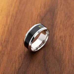 Smart titanium steel temperature ring in black and silver on wood background