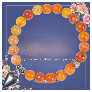 Detailed view of 8mm orange agate beaded bracelet with heart pendant and healing card