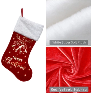 Detail view of red velvet Christmas stocking with white plush cuff and gold bell patterns