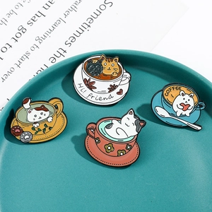 Detailed view of creative cat coffee cup enamel pins on a Morandi blue tray