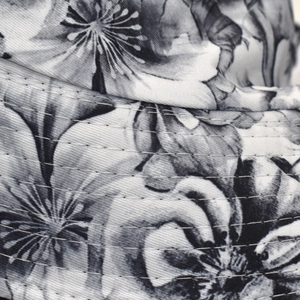 Macro detail of floral print bucket hat brim with reinforced multi-row stitching